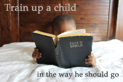 Child reading a very large Bible. Child reading a very large Bible.